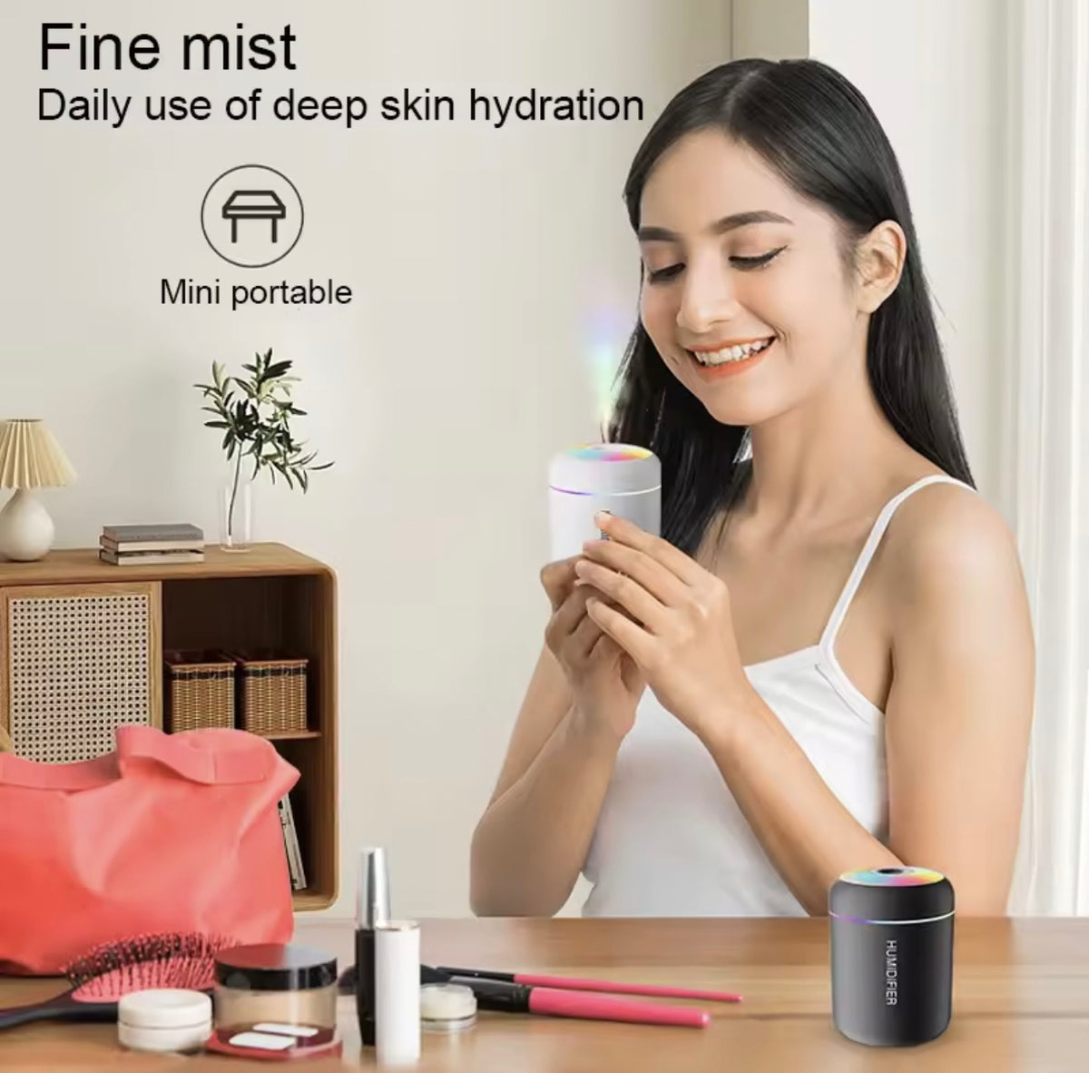 A woman in a white tank top holds a small cylindrical skincare device with a glowing multicolor top, while another similar device sits on a table in the foreground. Text on the left reads 'Fine mist Daily use of deep skin hydration' and 'Mini portable'.